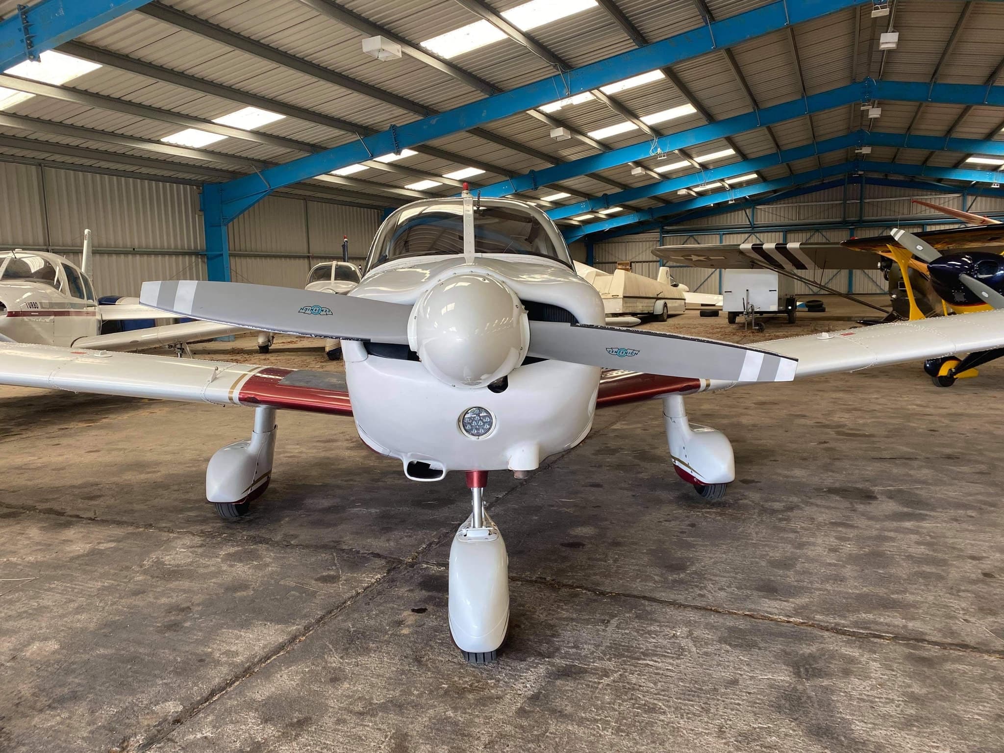 Nose-on view in the hangar showing the engine cowling and propeller